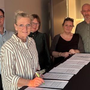 Foto af Birgitte Conradsen, der skriver under