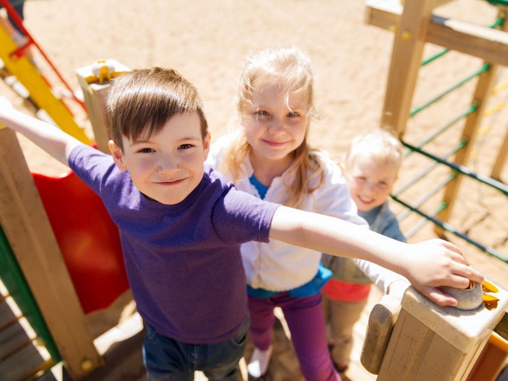 Glade børn på vej op i et klatrestativ